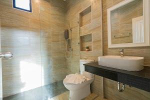 a bathroom with a toilet and a sink and a shower at White berry pool villa aonang in Krabi town +13 photos