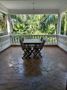 a patio with a table and chairs on a balcony at Kk bnb in Mombasa