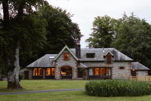 a stone house with a gray roof at The Coach House in Castle Douglas