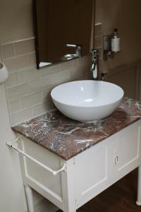 a white sink on a counter in a bathroom at The Coach House in Castle Douglas +37 photos