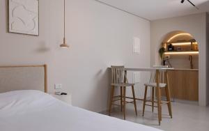 a bedroom with a bed and a table and stools at נופש ספיר אילת romantic in Eilat