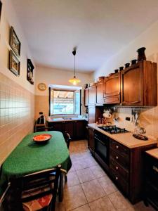 a kitchen with a table with a green table cloth at Residenza Magister in Serramonacesca +10 photos