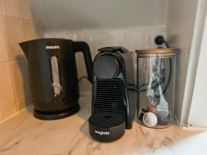 a kitchen counter with a coffee maker and a blender at Cozy apartment in Enschede