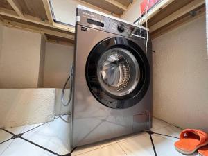 a washing machine sitting in a laundry room at Best hotel in Yakkasaray