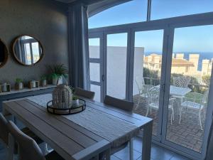 a table on a balcony with a view of the ocean at Pinnacle Golf Villa 24-3 in DʼAlmeida