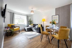a living room with a couch and a table at Spacious Apartment near MCR Airport in Wythenshawe