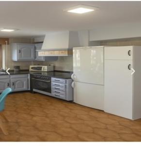 a kitchen with white appliances and a white refrigerator at apartamento 1 matrimonial con terraza acristalada in Tapia de Casariego