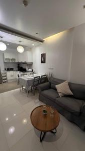 a living room with a couch and a table at The Lago apart Nai Harn beach 5min in Rawai Beach