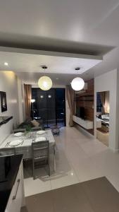 a dining room and living room with a table and lights at The Lago apart Nai Harn beach 5min in Rawai Beach