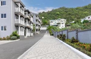 an empty street in a city with houses at Redhills Escape in Kingston