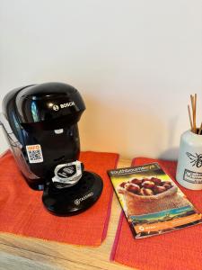 a coffee maker sitting on a table next to a magazine at SOBO Studio in Bournemouth