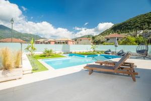 a villa with a swimming pool and a bench at Villa Pietra Di Mare in Yénion