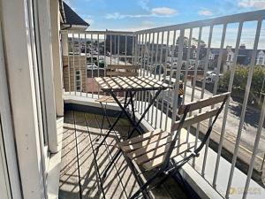 a chair sitting on a balcony with a table at The Lucas - Donnini Apartments in Ayr