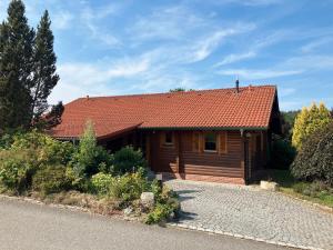 Cabaña de madera con techo rojo en una carretera en Landhaus An der Schafgasse, en Spittelstein