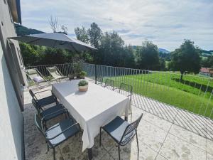 a table and chairs with an umbrella on a patio at Refugium im Wald in Riefensberg