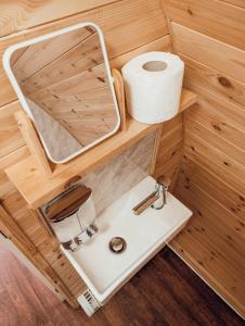 a bathroom with a sink and a roll of toilet paper at Strathyre Camping Pods in Strathyre