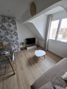 a living room with a couch and a table at L'appartement cosy du Portel in Le Portel +16 photos