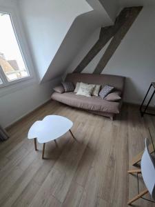 a living room with a couch and a table at L'appartement cosy du Portel in Le Portel