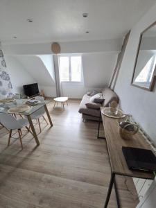 a living room with a couch and a table at L'appartement cosy du Portel in Le Portel