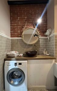 a bathroom with a washing machine and a mirror at Luxury apartment ЖК Вавилон Mountain View in Almaty