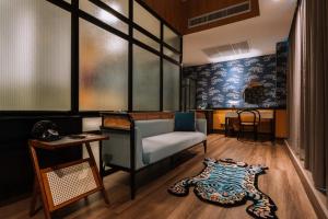a living room with a couch and a table at Urbanli Hatyai Hotel in Hat Yai