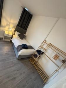 a bedroom with a bed and a ladder in it at City Escape Stylish 4 bedroom house in Nottingham in Nottingham +24 photos