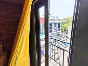 a window with a view of a parking lot at Smile Hotel Titiwangsa Pekeliling Sentul in Kuala Lumpur