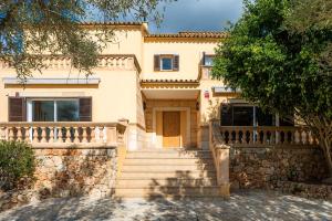 a house with stairs in front of it at Ses Tanquetes in Pina