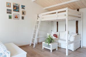 a white bunk bed with a ladder in a room at Gite El Camino in LʼHerbergement