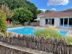 a swimming pool in the backyard of a house at Gite El Camino in LʼHerbergement
