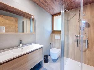 a bathroom with a toilet and a sink and a shower at Gervonne 3 in Montriond