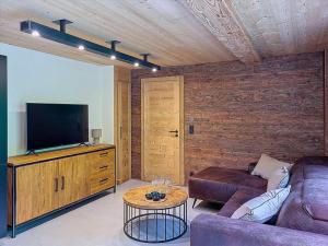 a living room with a couch and a flat screen tv at Gervonne 3 in Montriond