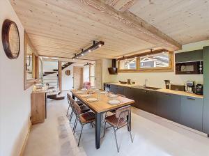 a kitchen and dining room with a table and chairs at Gervonne 3 in Montriond