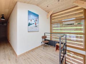 a staircase in a house with a painting on the wall at Gervonne 3 in Montriond +10 photos