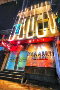 a building with signs on the side of it at Hotel Maa Aarti Palace in Ujjain