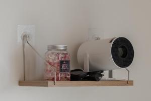 a air conditioner and a jar on a shelf with a mixer at Free Wi-Fi, 7 minutes' walk from Nishitetsu Futsukaichi Station in Chikushino