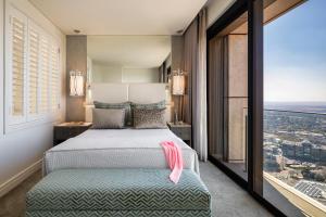 a hotel room with a bed and a large window at The Leonardo in Johannesburg +79 photos