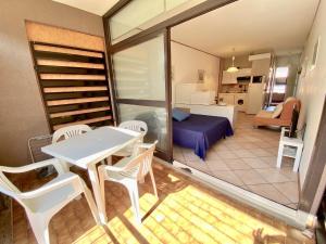 a balcony with a table and chairs and a room at Appartamenti del Mare in Marina di Bibbona
