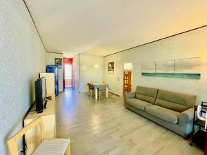 a living room with a couch and a table at Appartamenti del Mare in Marina di Bibbona