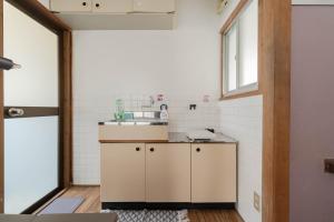 a small kitchen with a sink and a window at Free Wi-Fi, 7 minutes' walk from Nishitetsu Futsukaichi Station in Chikushino