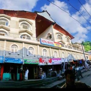 a large building on the side of a street at Kings Hotel in Dargai