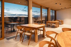 a dining room with tables and chairs and large windows at Emeran Reya Estate in Šmartno