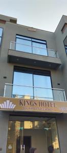 a building with a sign for a kings hotel at Kings Hotel in Dargai