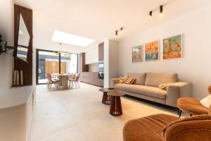 a living room with a couch and a table at Mademoiselle Julie in Diksmuide