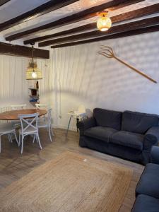 a living room with a blue couch and a table at Cal Papa in La Pobla de Lillet