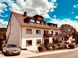 a car parked in front of a large house at Familienapartment in Bad Orb