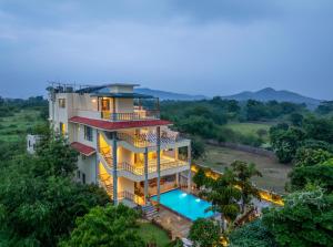 an aerial view of a house with a swimming pool at Dilip Niwas Luxe Stay - Near Fateh Sagar Lake 2 KM in Udaipur