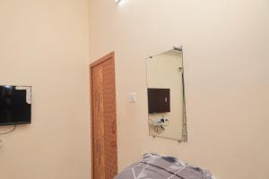 a mirror on a wall next to a room at Magesh Residency in Jāmb