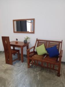 a room with two chairs and a table and a mirror at Danu Surf House Hiriketiya in Dickwella