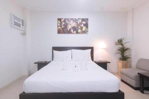 Postel nebo postele na pokoji v ubytování Propiedad Residences Makati